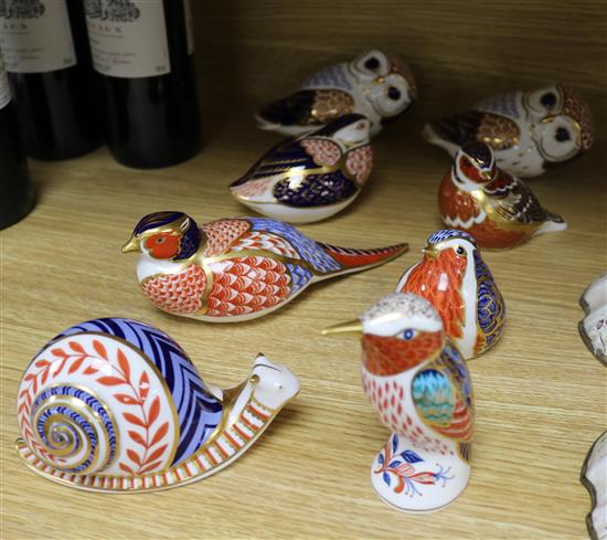 Eight assorted Royal Crown Derby paperweights, modelled as birds and a snail